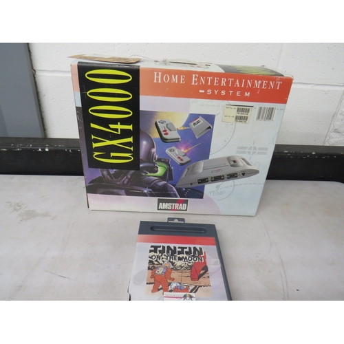 414 - Amstrad GX4000 game system in original box with TinTin on the moon game