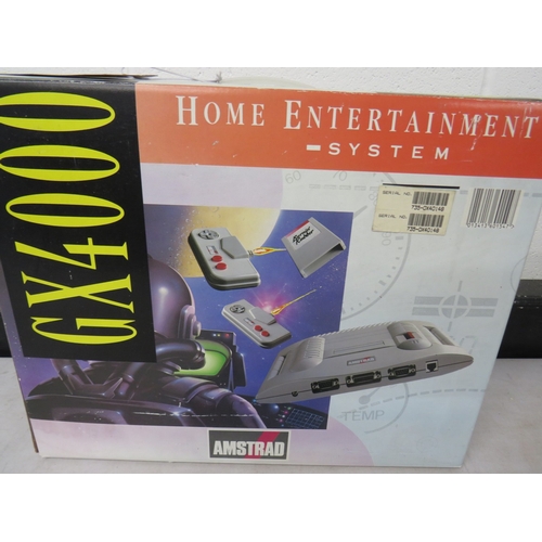 414 - Amstrad GX4000 game system in original box with TinTin on the moon game