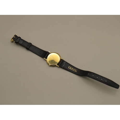 5 - Gucci watch with leather strap