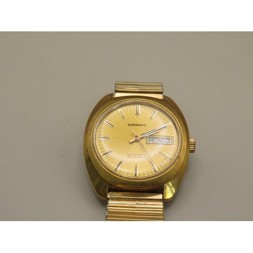 13 - Gold tone Garrard day date watch