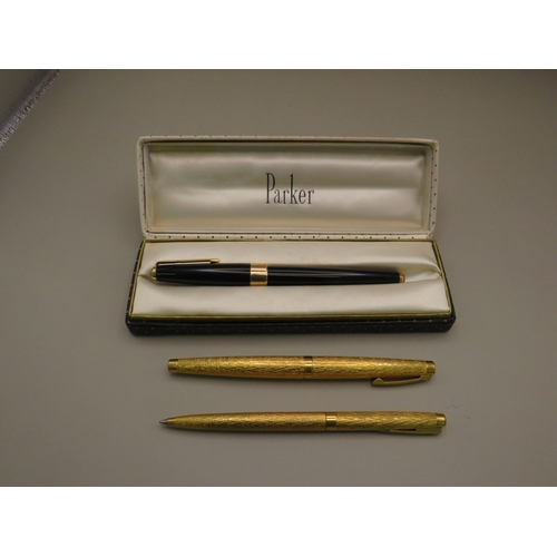 25 - Boxed Parker pen and two other gold tone pens