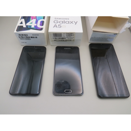 39 - Three boxed samsung phones plus two others - untested