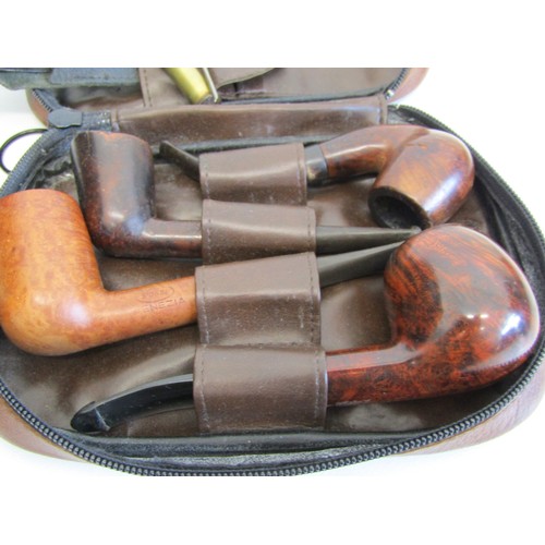 82 - Brown leather pipe tobacco pouch with pipes and accessories.