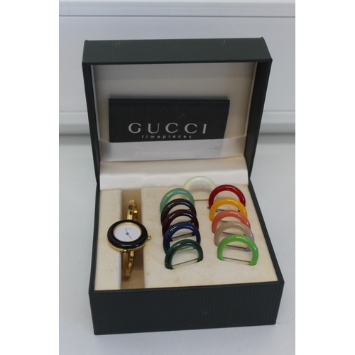 16 - Gucci wristwatch with twelve different coloured bezels