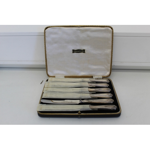 23 - Cased set of six butter knives with sterling silver handles