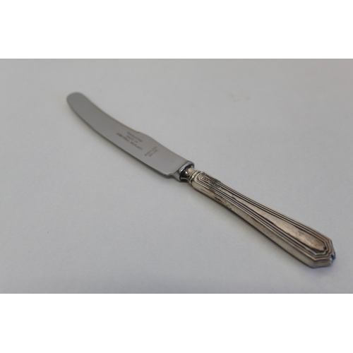 23 - Cased set of six butter knives with sterling silver handles
