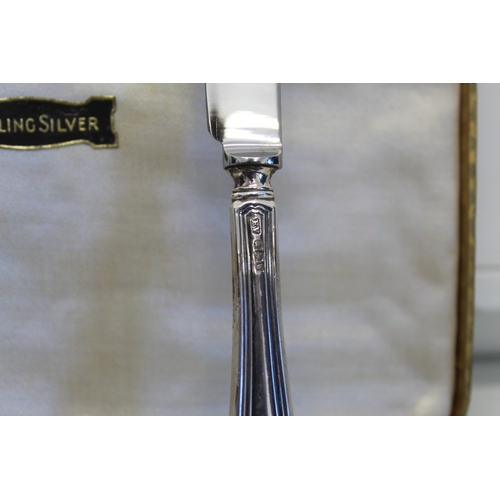 23 - Cased set of six butter knives with sterling silver handles