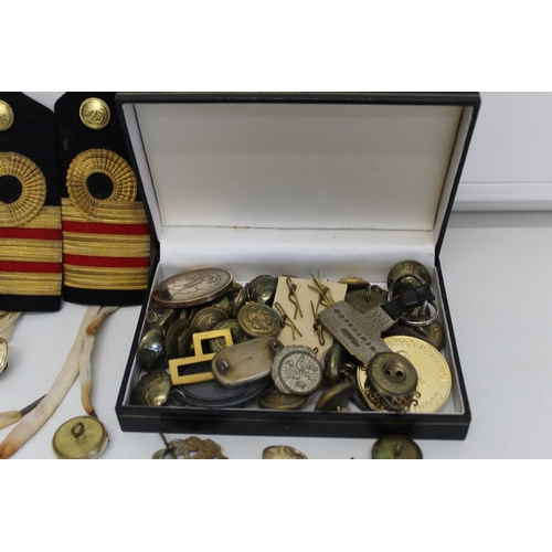 33 - Job lot of assorted badges largely consisting of military
