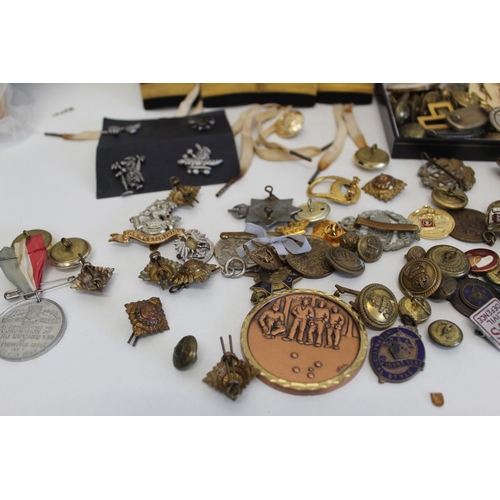 33 - Job lot of assorted badges largely consisting of military