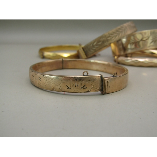 27 - Six gold plated/rolled gold bangles