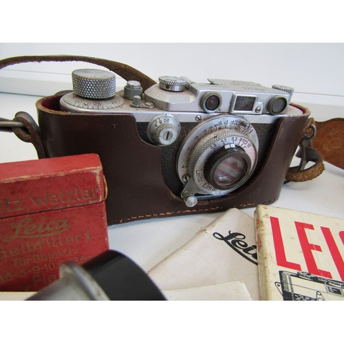 16 - Leica camera with a lens and instruction booklets