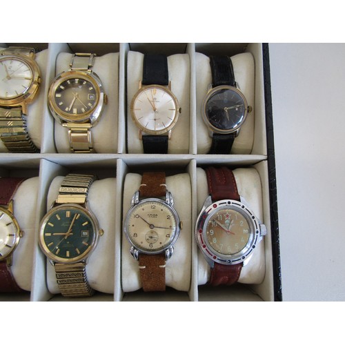 28 - Ten mechanical watches in a display case