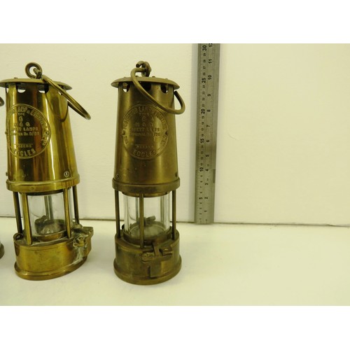 57 - Three full size miner's lamps