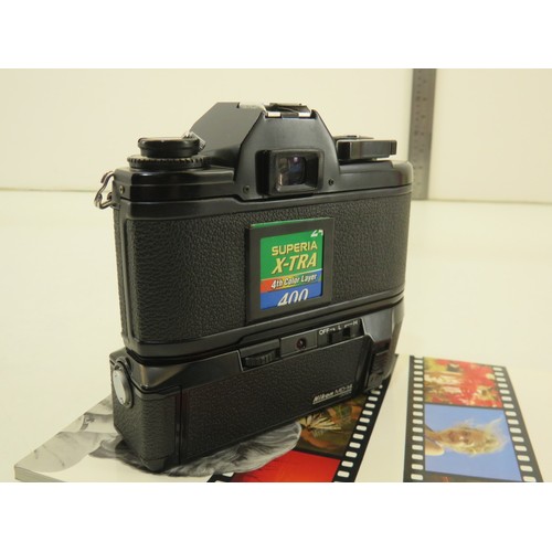 19 - Nikon EM camera with booklet