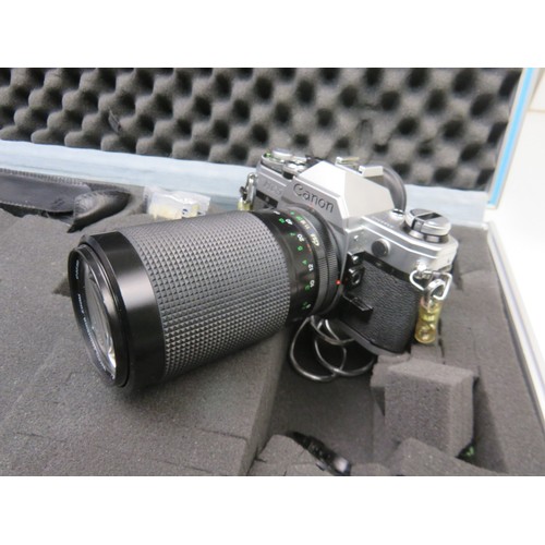 53 - Canon AE-1 camera with lenses and accessories in a flight case