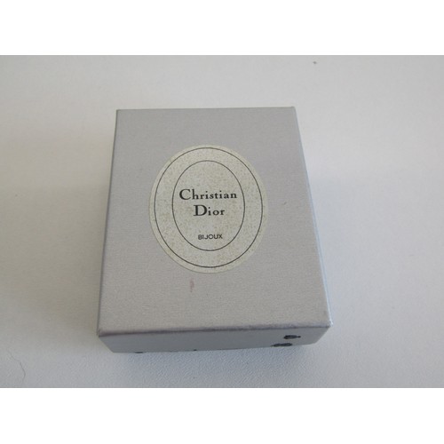 20 - Three Christian Dior stick pins and box.
