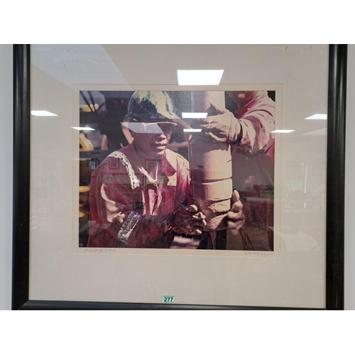 277 - Framed picture of oil worker, A Helping Hand, signed, 100cm x 90cm approx
