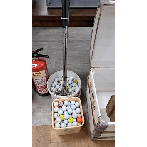 485 - Good selection of golf balls and older clubs