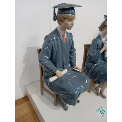 41 - Lladro male and female graduation figurines
