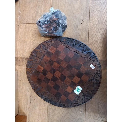 48 - Carved wooden chess board and pieces