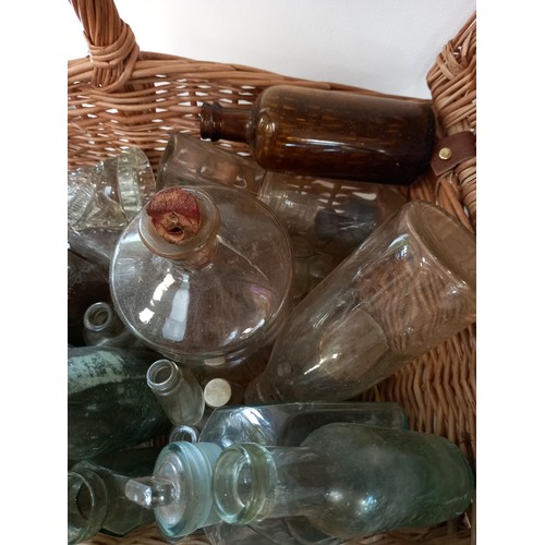 175 - Wicker basket with collectible bottles