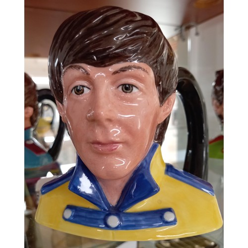 104 - Royal Doulton 1984 'The Beatles' Toby Jugs.  To include: Paul McCartney, John Lennon, Ringo Star and... 