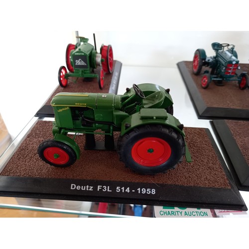 284 - Collection of 21 Atlas Edition model tractors, with certificates