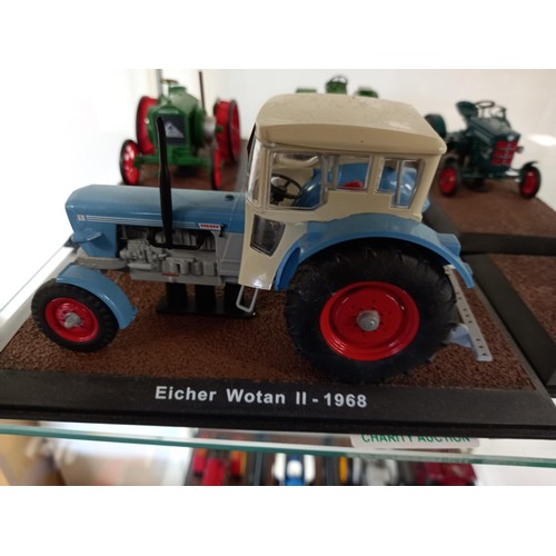 284 - Collection of 21 Atlas Edition model tractors, with certificates