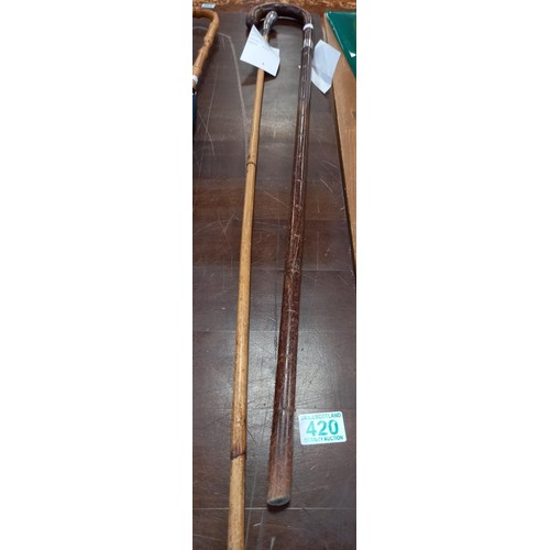 420 - A pair of walking canes 1 with pistol grip handle London 1908 assay mark, other 1922 assay mark