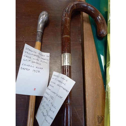 420 - A pair of walking canes 1 with pistol grip handle London 1908 assay mark, other 1922 assay mark