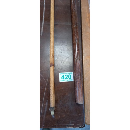 420 - A pair of walking canes 1 with pistol grip handle London 1908 assay mark, other 1922 assay mark