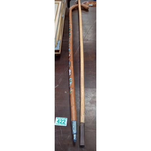 422 - Horn handled walking stick and wooden walking stick with badges