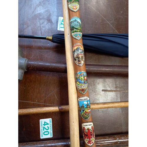 422 - Horn handled walking stick and wooden walking stick with badges