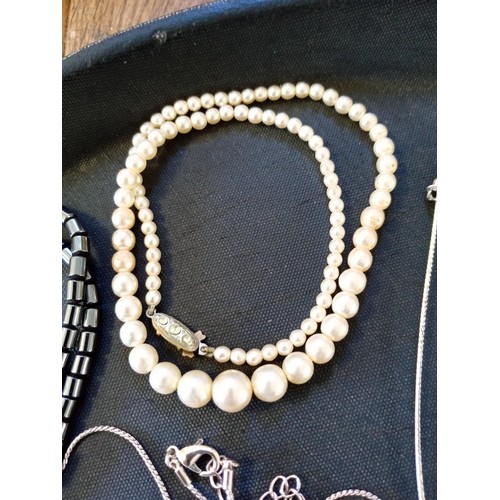 574 - A pretty selection of necklaces with pendants including real pearls