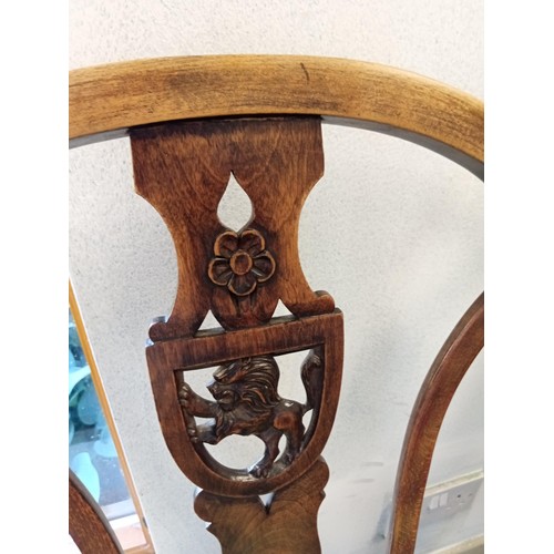 389 - one carver and eight other dining table chairs with rose and lion carved shields