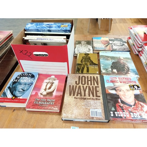 574 - A good selection of John Wayne books etc