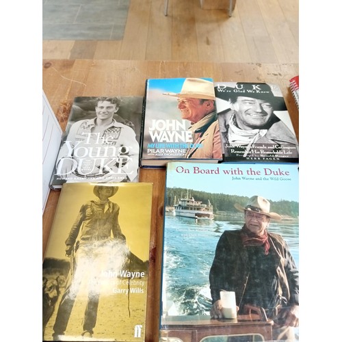 574 - A good selection of John Wayne books etc