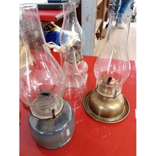 203 - Selection of oil lamps and stair chimney glass