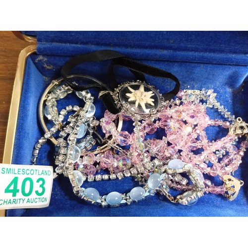 403 - A selection of costume jewellery in an original jewellery box