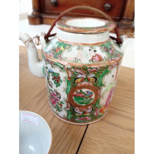 33 - oriental teapot in basket with cup and one other