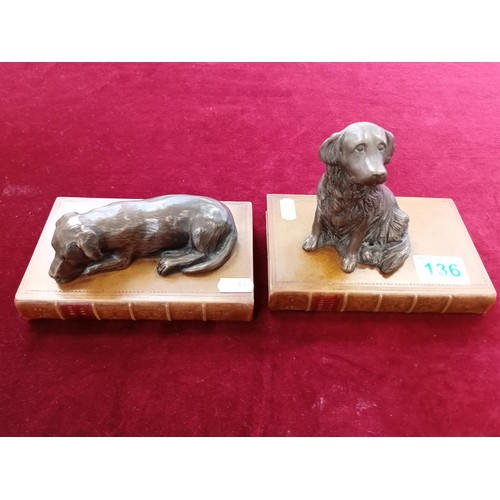 136 - 2 x ornamental dogs on books figurines