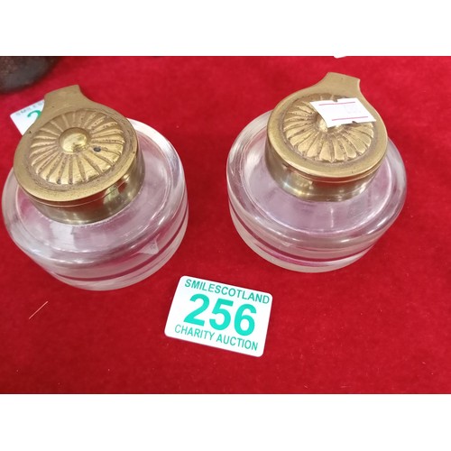 256 - a pair of brass topped on glass ink stands