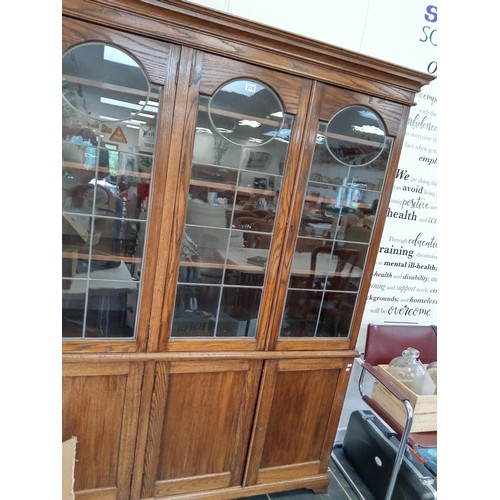 278 - large bookcase with 4 door cupboards and leaded glass