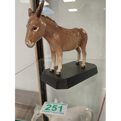 251 - Beswick England Donkey on wooden plinth.