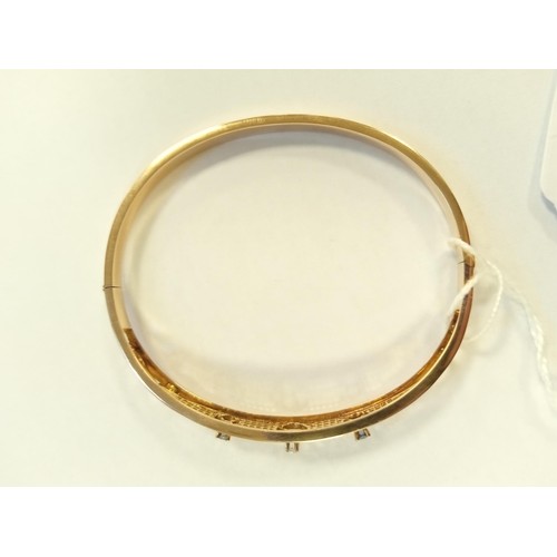 62 - 10ct gold bangle with US patent, stone mounted,  8g approx.