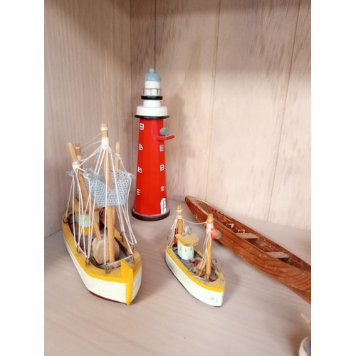 149 - Model boats, lighthouses and a ship in a bottle