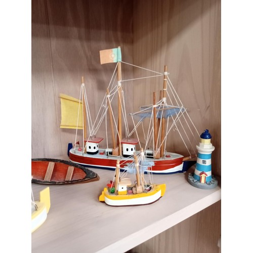 149 - Model boats, lighthouses and a ship in a bottle