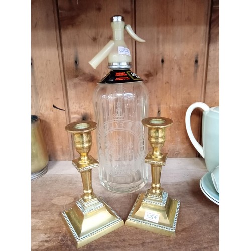 222 - Vintage Schweppes soda syphon and a pair of brass candle holders