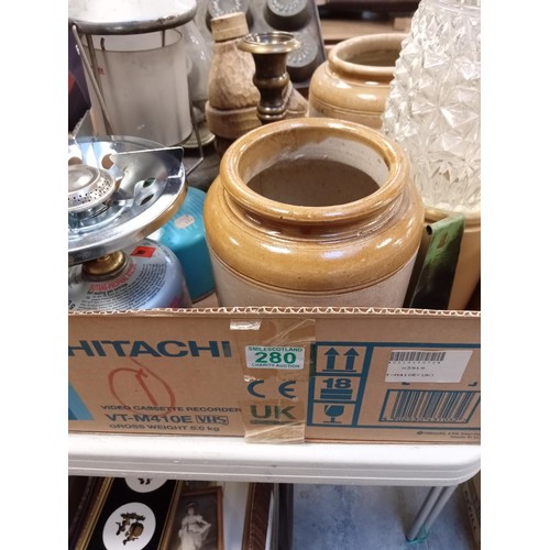 280 - Box lot containing oil lamp, gas stove, glazed pots etc