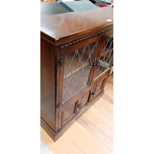 263 - Leaded glass bookcase with small cupboard below 103cm H approx.